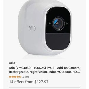 Two new Arlo add on cameras in box with magnetic mount screws and charger.